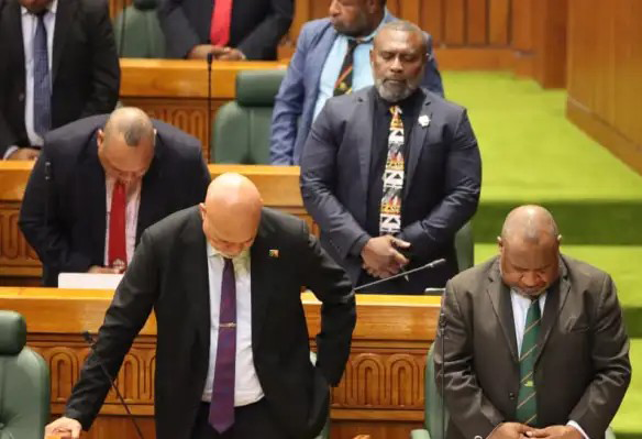 MPs, including Peter Tsiamalili Jr (middle row, right), praying in Parliament on Aug 25, ahead of deliberations on whether to ratify Bougainville’s vote for independence. — Picture by the PNG Prime Ministers Media Unit