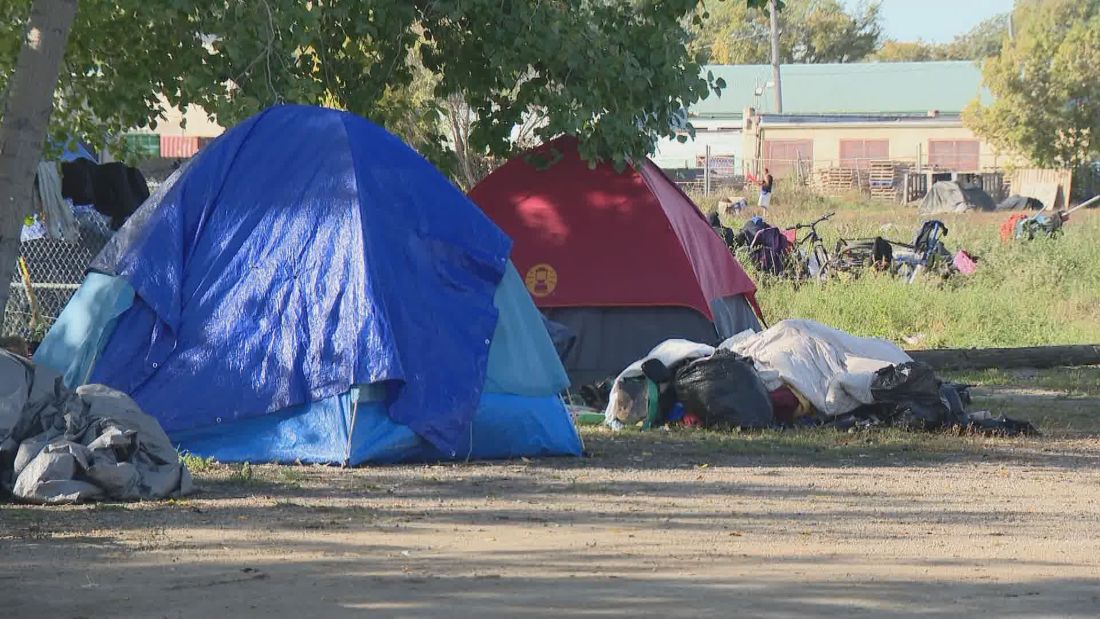 The planned clean-up of two encampments has been paused due to aggressive protests, the City of Saskatoon said.