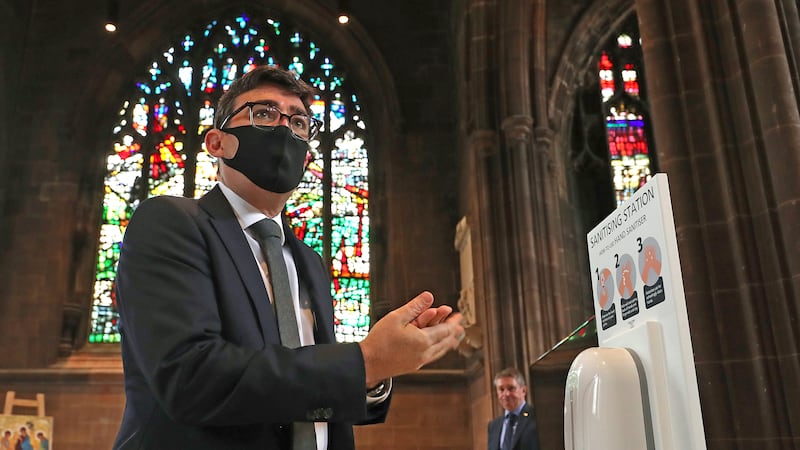 Mr Burnham sanitises his hands before a memorial service for victims of Covid at Manchester Cathedral in 2020
