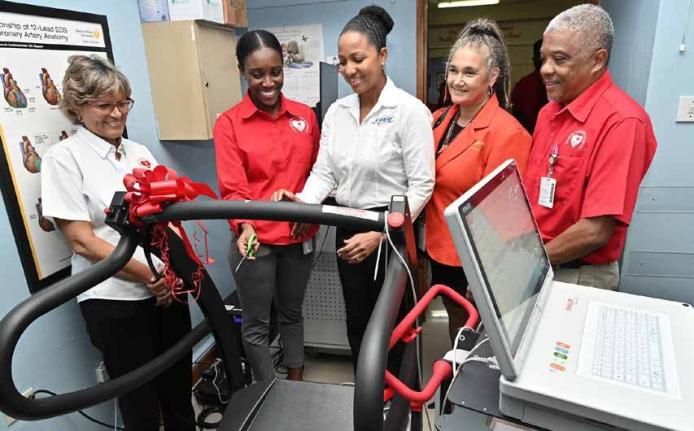 Heart Foundation of Jamaica (HFJ) Executive Director Deborah Chen (left) is delighted with equipment donated to the HFJ by the CHASE Fund in November 2025. CHASE Projects Manager Latoya Foster (centre) tests the controls after the presentation. Sharing in