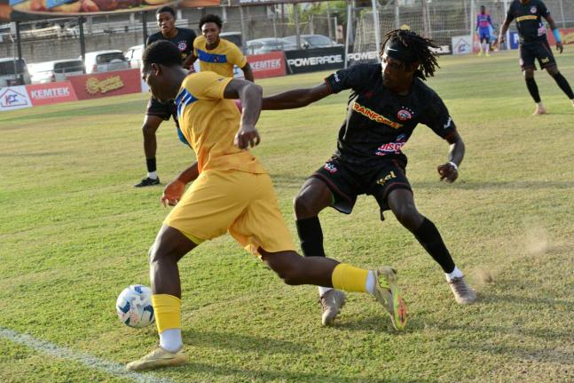 Deonjay Brown (right) of Montego Bay United and Adriel George of Racing United battle for the ball during their Jamaica Premier League match at the Waterhouse Mini Stadium yesterday. Rudolph Brown/Photographer