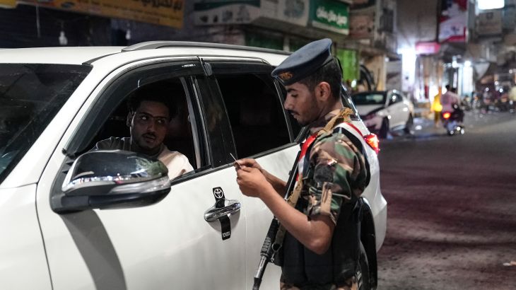 A member of the security forces of the internationally-recognised Yemeni government mans a checkpoint on a street in Taiz amid concerns over Houthi infiltration, late on September 27, 2026. Following several years of relative calm, Yemen's war reignited in July, against the backdrop of the widening Middle East war. Fighting intensified in September as the Houthis launched a lightning offensive that saw them seize Yemen's entire Red Sea coast, including the Bab al-Mandab Strait, a vital